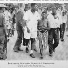 Newspaper cutting showing a photo of Pauline Lumumba walking bare-breasted in the streets of Leopoldville after the death of her husband &mdash; The New York Times